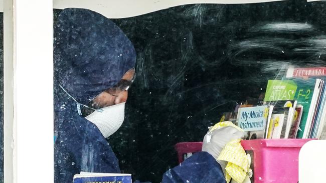 A cleaner inside a classroom at Meadowglen Primary School in Melbourne after a pupil tested positive in May. Picture: AAP.