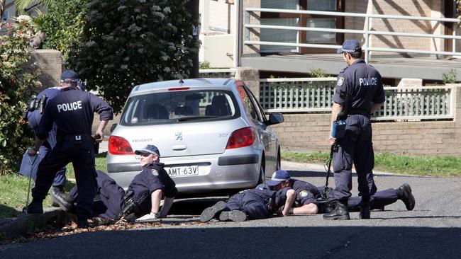 Police searching for evidence at the scene of the execution style murder of Sydney businesses man Michael McGurk. Picture: Jeff Herbert