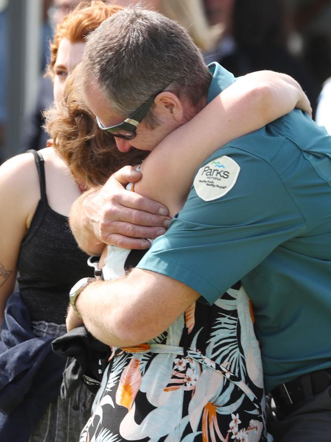 Friends embrace at the funeral of firefighter Bill Slade. Picture: AAP