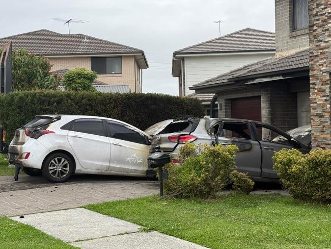 The two cars which were set alight on Tuesday morning on San Cristobal Dr, Green Valley. Picture: Aymon Bertah