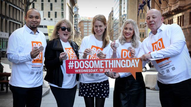 DoSomething Day 2017. Martin Place Activation. L-R; Carlos Curiel, Karen Neumann, Cathy Morris, Kimberley Caines and Mark Nulty give out DoSomethingday info and chocolates in Martin Place . NSW. Wednesday, July 19, 2017 (AAP Image / Chris Pavlich)