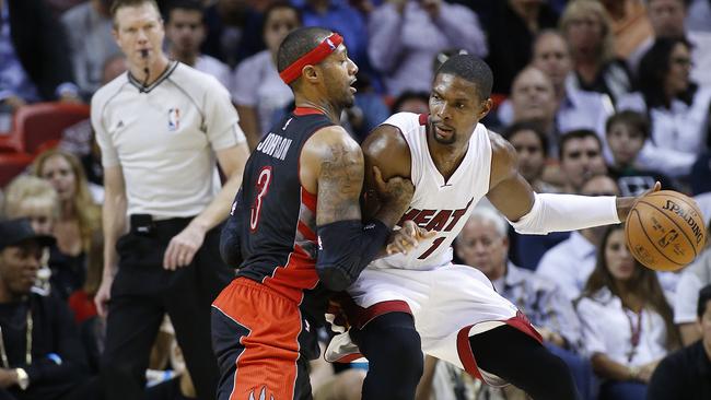 Chris Bosh goes to work against James Johnson in Miami’s win.