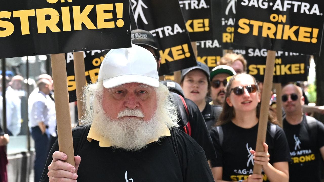 Members of the Writers Guild of America and the Screen Actors Guild walk a picket line outside NBC Universal in New York City. Picture: TIMOTHY A. CLARY / AFP