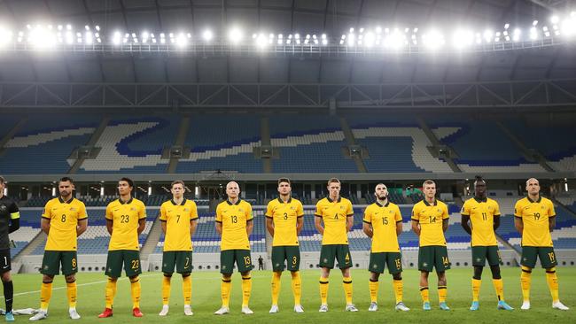The Australia team line up for the national anthems in Doha. Photo by Mohamed Farag/Getty Images.