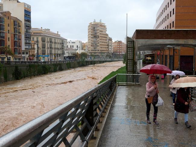 Flood waters gush down a canal in Malaga. Picture: Getty Images