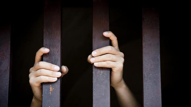 Prisoner, hands holding bars, jail, behind bars, children behind bars, asylum seeker generic, detention center, detained, jailed, shame, sadness, mental health, restriction, limitation generic, thinkstock