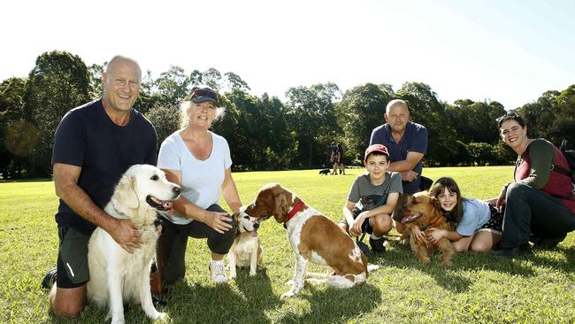 Chris Miles and Kirstin McGregor with their dogs Millie, Baxter and Jenna, and Patrick Haluza, 11, Pavel Haluza, Olivia Haluza, 9, and Roslyn Bathgate with their dog Freddy in Cowells Lane Reserve at Ermington. Picture: John Appleyard