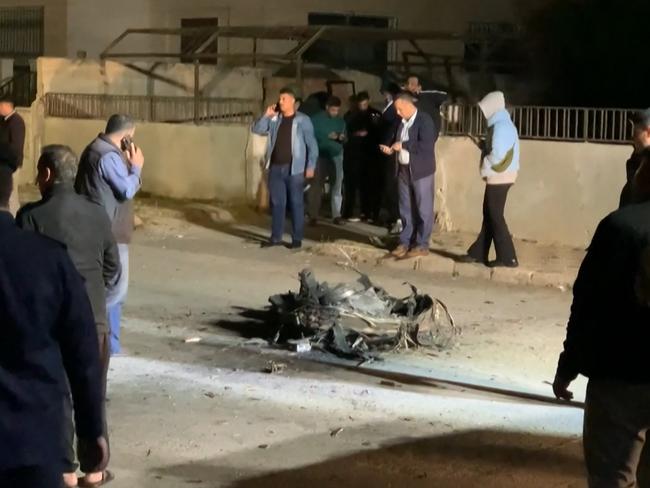Jordanian onlookers and security agents standing around the debris of a missile that the Jordanian forces intercepted over Amman amid an unprecedented Iranian attack on Israel. Picture: AFP