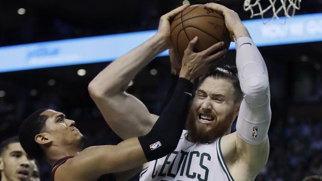 Boston Celtics centre Aron Baynes competes for a rebound against Cleveland Cavaliers guard Jordan Clarkson in Boston. Picture: AP.