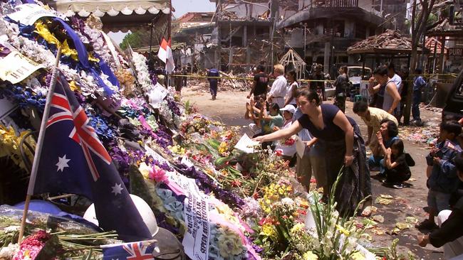 FLASHBACK: Relatives and friends of the Bali bombing victims place offerings at the scene of the tragedy, the Sari nightclub, during the national day of mourning.