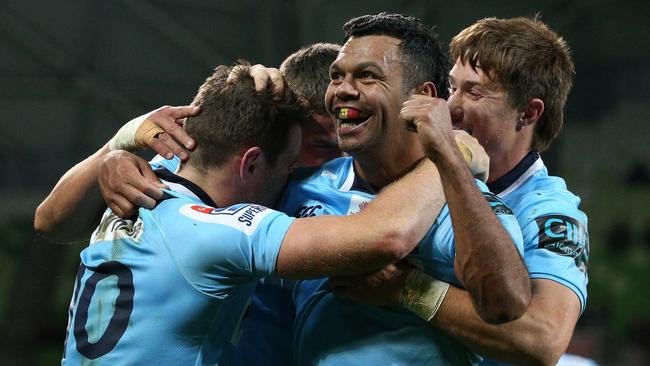 Kurtley Beale celebrates with teammates after the Waratahs’ great escape against the Rebels. Picture: AAP