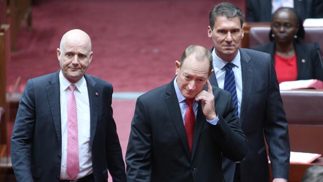 Senator Fraser Anning being escorted into the federal chamber by senators Cory Benardi and David Leyonhjelm. Picture: Gary Ramage