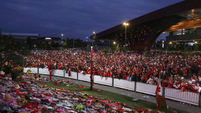 Hockey fans hold Flames phone app candles during the candlelight vigil for former Calgary Flames star Johnny Gaudreau and his brother Matthew. Photo by Leah Hennel / GETTY IMAGES NORTH AMERICA / Getty Images via AFP.