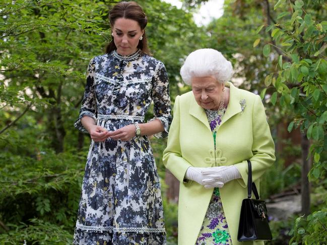 Catherine, Duchess of Cambridge shows Britain's Queen Elizabeth II and Britain's Prince William, Duke of Cambridge, around the 'Back to Nature Garden' garden, that she helped design. Picture: AFP