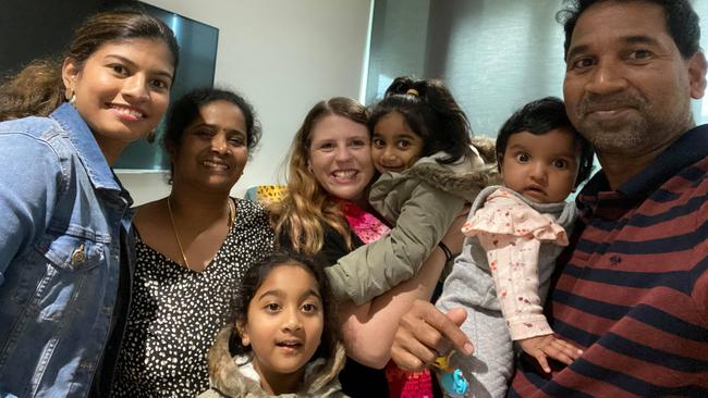 The reunited Murugappan family, Priya, second left, Nades, right, and daughters Kopika, centre, and Tharnicaa, bottom, pictured with supporters at Perth Children's Hospital on Thursday. They have since been released from hospital into community detention in Perth.