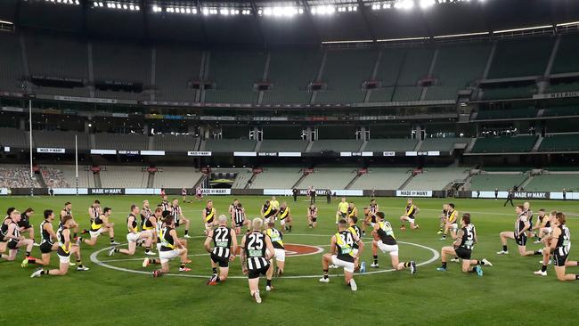 Players take a knee to support the Black Lives Matter movement before the clash between the Collingwood Magpies and the Richmond Tigers at the MCG. Picture: Getty Images