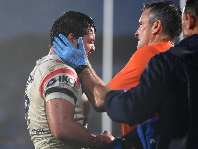 Brandon Smith is taken off for concussion during the round nine NRL match between New Zealand Warriors and Sydney Roosters in Auckland. Picture: Hannah Peters/Getty Images.