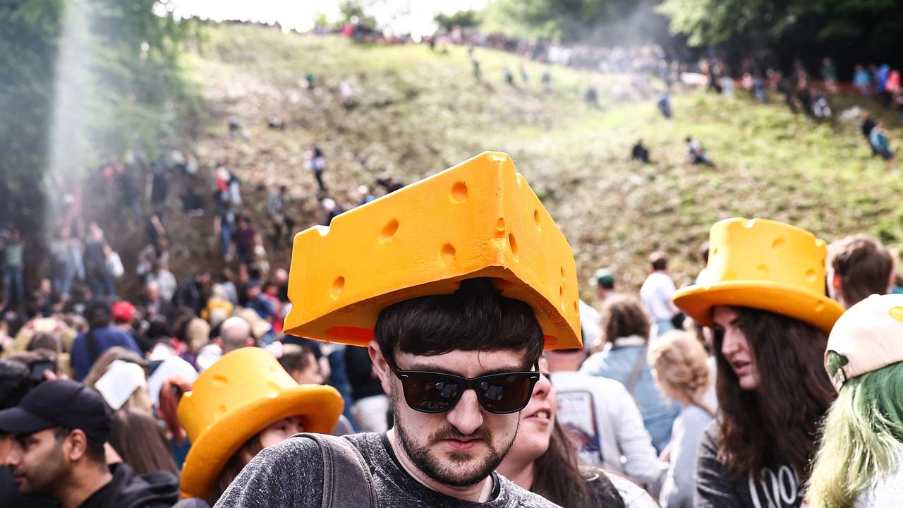 Tourists flock to the town kitted out with cheese merch to watch the event. Picture: Henry Nicholls/AFP