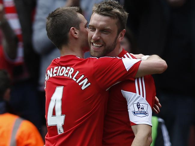 Southampton's Rickie Lambert, right, celebrates his goal against Manchester United with teammate Morgan Schneiderlin during their English Premier League soccer match at St Mary's stadium, Southampton, England, Sunday, May 11, 2014. (AP Photo/Sang Tan)