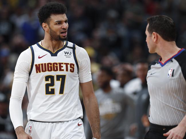 Denver Nuggets guard Jamal Murray (27) reacts after scoring a basket against the Milwaukee Bucks in the second half of an NBA basketball game Monday, March 9, 2020, in Denver. (AP Photo/David Zalubowski)