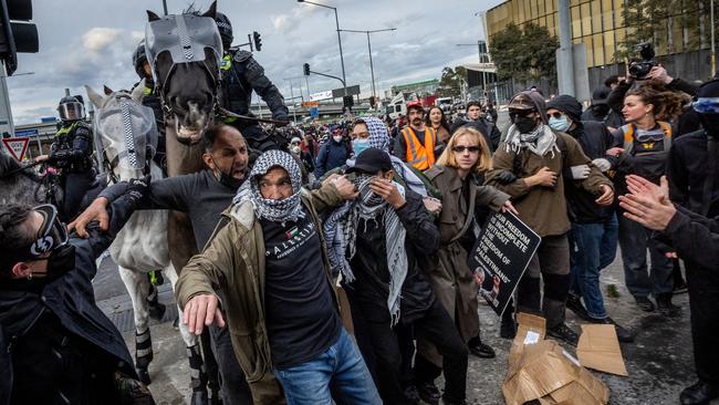 Violent protesters attacked police and bystanders, lit fires, hurled manure and other objects and spouted vile abuse during this week’s riots in Melbourne. Picture: Jake Nowakowski