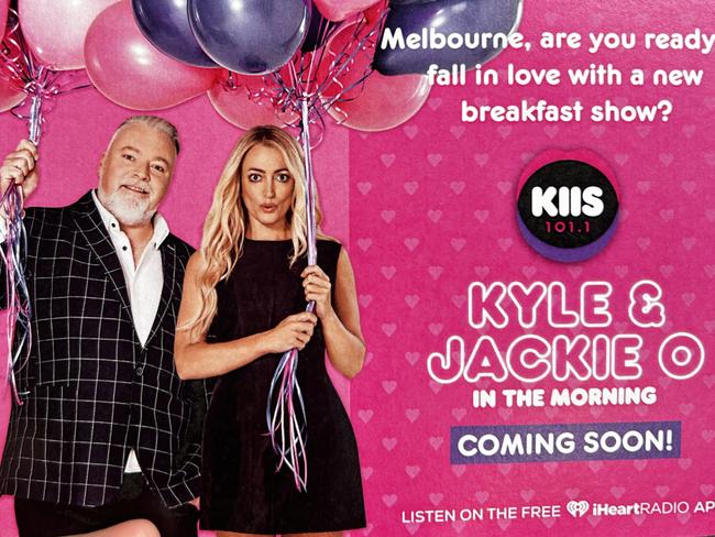 KIIS FM flyers promoting the Kyle and Jackie O Show being handed out at Richmond train station in Melbourne on February 14, 2024.