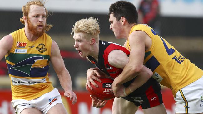 A fresh-faced John Noble gets tackled by Sam Rowland while Angus Poole playing for West Adelaide in 2017. Picture Sarah Reed