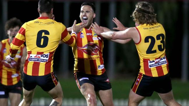 Morphettville Park’s Edward Doak celebrates one of his two first quarter goals with teammates Jack Sutto and Kye Dean in their preliminary final win over Walkerville at Glenelg Oval on Friday night. Picture: Dean Martin