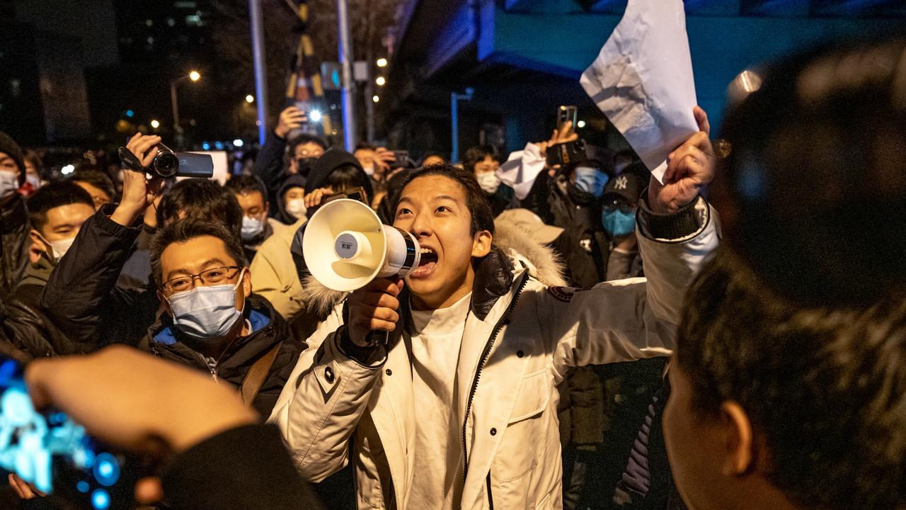 A demonstrator holds a blank sign and chants slogans during a protest in Beijing, China. Picture: Bloomberg