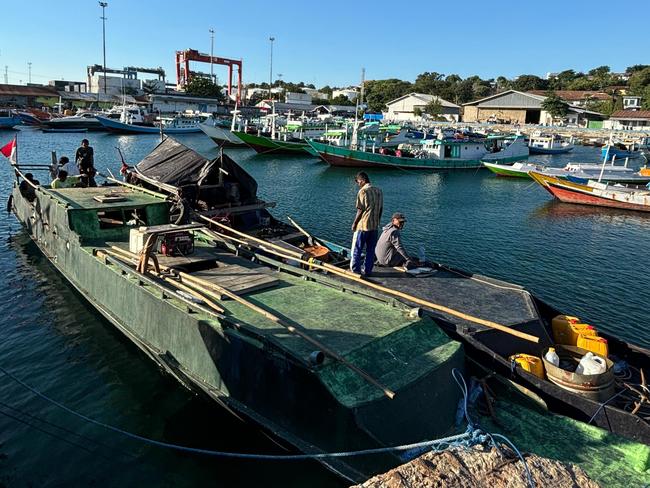 Indonesian Police and fisheries authorities display a heavily modified and camouflaged fishing boat detained in Kupang, East Nusa Tenggara, last Wednesday after it arrested six Chinese nationals, including a Chinese boat captain, and an indonesian crew on suspicion of attempting to smuggle would be asylum seekers into Australia.