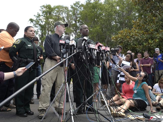 Nick Wiley, executive director of the Florida Fish &amp; Wildlife Conservation Commission, left, and Orange County Sheriff Jerry Demings during a news conference in Lake Buena Vista, Florida. Picture: Phelan M Ebenhack