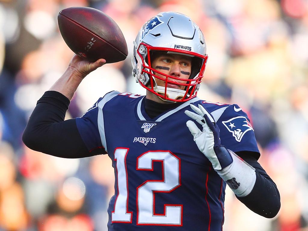 A dejected New England Patriots quarterback Tom Brady sits on the News  Photo - Getty Images