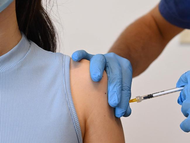 A woman is being vaccinated with the Pfizer-BioNTech vaccine at a Poliambulatorio Health Canter in the southern Italian Pelagie Island of Lampedusa on May 15, 2021. (Photo by Alberto PIZZOLI / AFP)