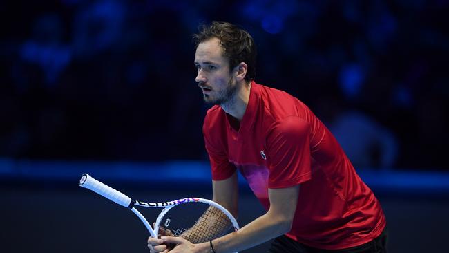 Daniil Medvedev returns a serve with his racket facing the wrong way. (Photo by Valerio Pennicino/Getty Images)