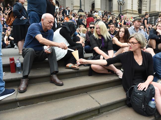 Saeed Maasarwe lights a candle at a vigil for his daughter Aiia on Friday. Picture: Tony Gough