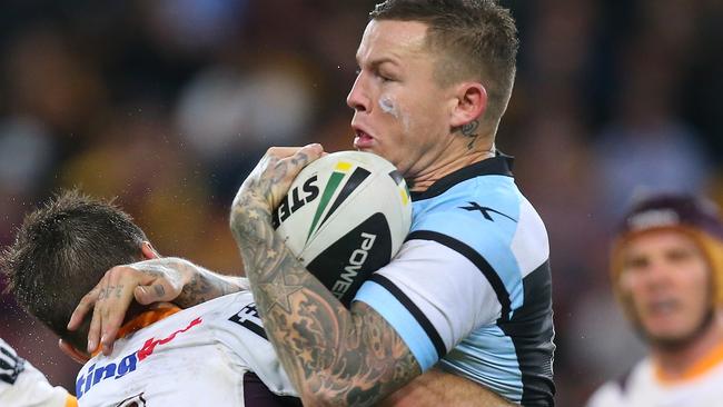 BRISBANE, AUSTRALIA - JUNE 27: Todd Carney of the Sharks is tackled by Ben Hunt of the Broncos during the round 16 NRL match between the Brisbane Broncos and the Cronulla Sharks at Suncorp Stadium on June 27, 2014 in Brisbane, Australia. (Photo by Chris Hyde/Getty Images)