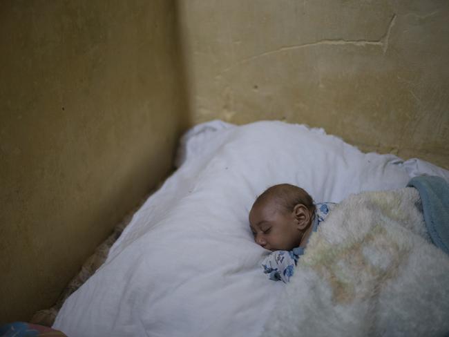 Brazilian baby Jose Wesley sleeps on his mother's bed in Bonito, Pernambuco state, Brazil. Jose Wesley has lost weight, from 7 to 5 kilograms, a huge drop for a baby who should be growing. Picture: Felipe Dana
