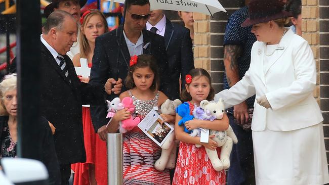 The twins’ father, Robert, walks with two of his daughters at the funeral service at Our Lady of the Angels Church, Rouse Hill. Picture: Adam Taylor