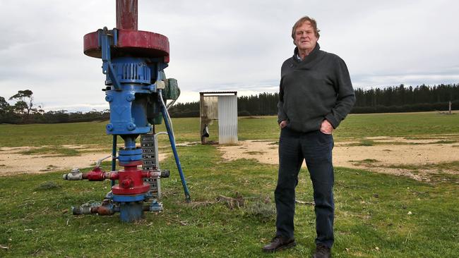 Farmer Gregor McNaughton with an unused coal seam gas well on his property near Seaspray, 200km southeast of Melbourne. Picture: Aaron Francis