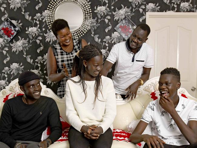 4/1/21 - SAWEEKEND feature on school-leavers and how COVID is affecting their plans for the future. Awur Ayuen Deng (centre), a year 12 graduate, hopes to become a lawyer. She lives at home in Salisbury Plains with 10 siblings including (L-R)  Akur Ayuen Deng (12), Deng Leek Aleer (19), Anyuat Ayuen Deng (13) and Atong Ayuen Deng (15) and parents Adut Aleer Deng and Solomon Ayuen Deng. Picture: Naomi Jellicoe