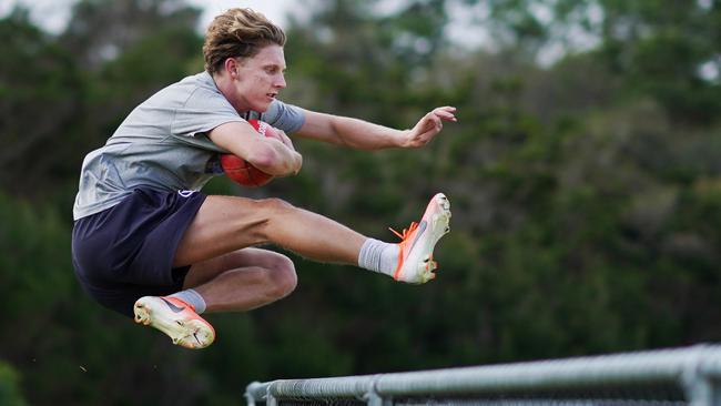 Giants star Lachie Whitfield hurdles a fence during a training session at Mount Martha in Melbourne Picture: AAP