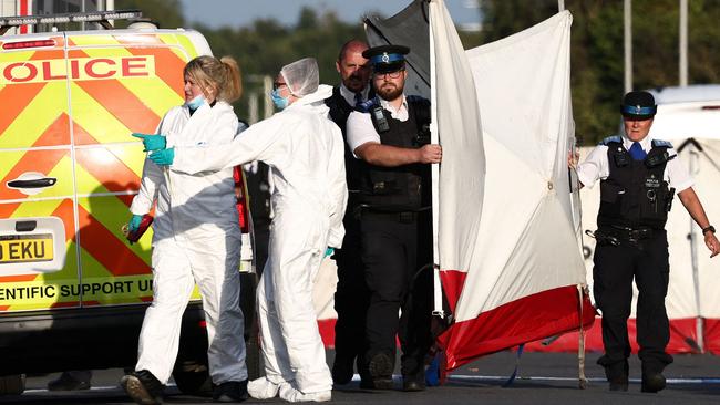 Police officers and forensic personnel put up a fence in Southport, northwest England, following the knife attack. Picture: AFP,