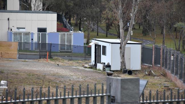 A portable security shed surrounded by weeds and discarded building materials is seen on a vacant land, which is a proposed new Russian embassy site in Canberra. Picture: AFP