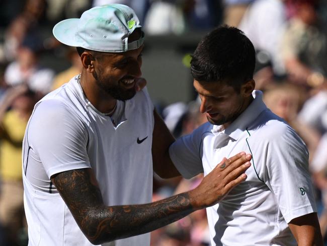 Australia's Nick Kyrgios (L) congratulates Serbia's Novak Djokovic for his victory during their men's singles final tennis match on the fourteenth day of the 2022 Wimbledon Championships at The All England Tennis Club in Wimbledon, southwest London, on July 10, 2022. (Photo by SEBASTIEN BOZON / AFP) / RESTRICTED TO EDITORIAL USE