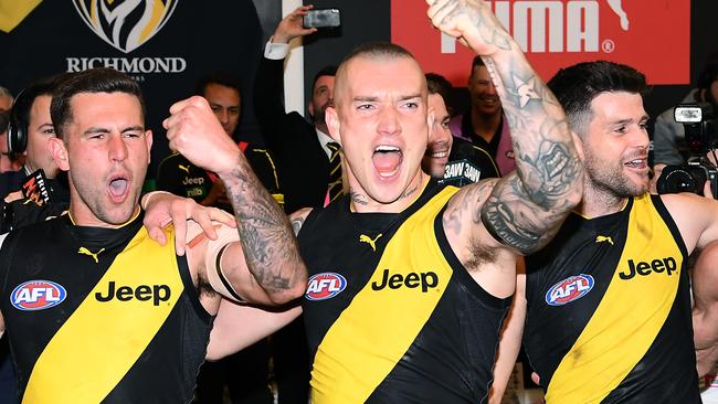 Jack Graham, Dustin Martin and Trent Cotchin of the Tigers sing the song.