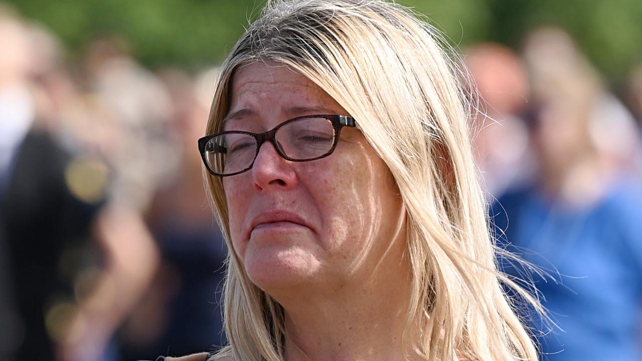 A tearful mourner watches the procession for Queen Elizabeth II at the Hyde Park screening site. Picture: Stuart C. Wilson/Getty Images