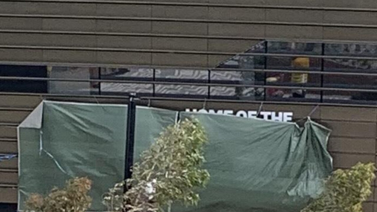 The "Home of the Sydney Roosters" sign at Allianz Stadium covered up by a $152 Bunnings tarpaulin.