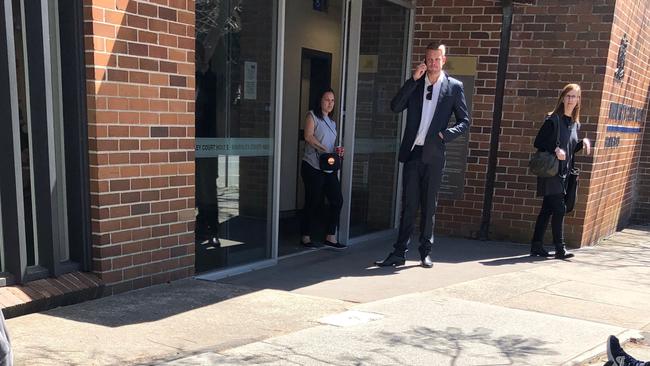 James McKaig (centre) outside court on Wednesday.