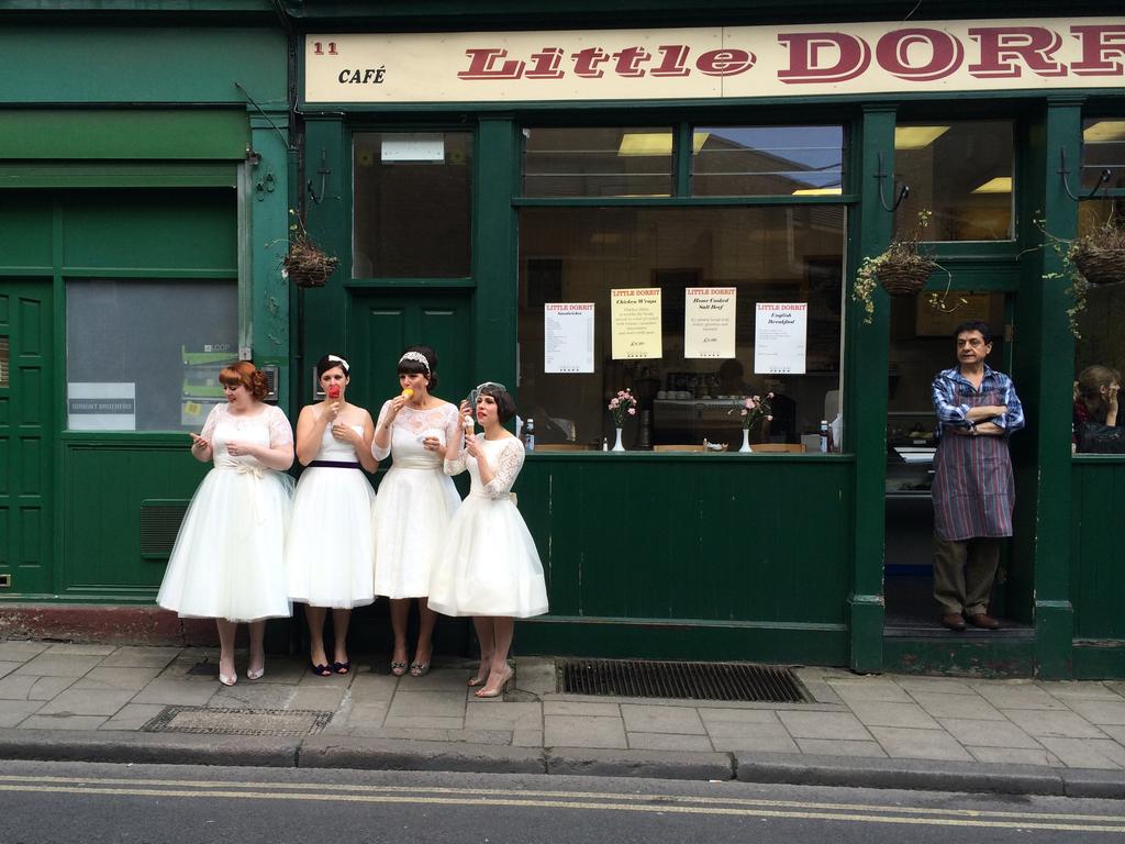 “Ladies in waiting” by Susie Stern / National Geographic Traveler Photo Contest. While exploring Burough Market in London, I was delighted to come across four lovely young women dressed in vintage white dresses, eating ice cream as the local shopkeeper looked on. Are they brides? Or bridesmaids. I don’t know, but they are obviously enjoying a very special day. Location: Burough Market, London, England. Picture: <a href="http://travel.nationalgeographic.com/travel/traveler-magazine/photo-contest/2014" target="_blank">National Geographic Photo Contest </a>