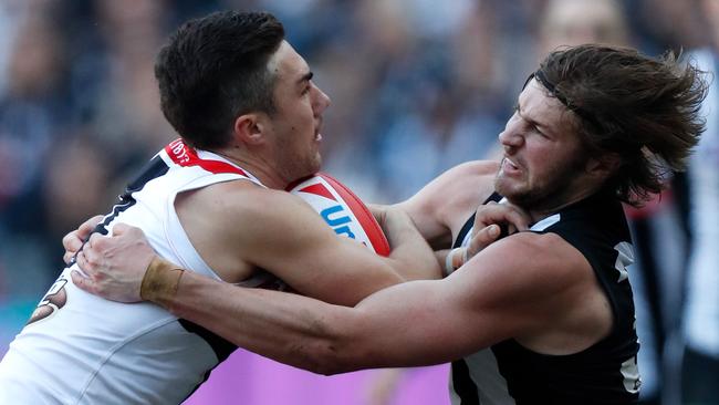 Jade Gresham of the Saints is tackled by Rupert Wills of the Magpies